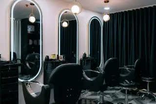Hair styling studio with arched mirrors and styling chairs