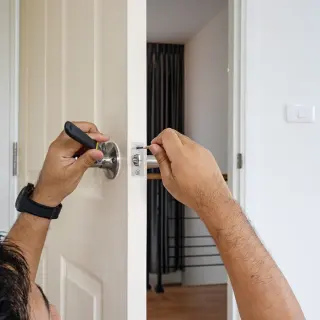Technician adjusting a home security system panel