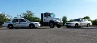 Three vehicles on an empty road