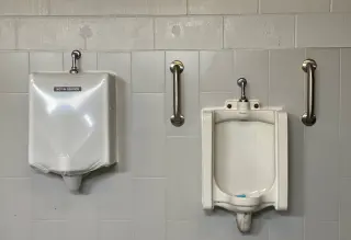 SaniCover urinal cover in a commercial restroom