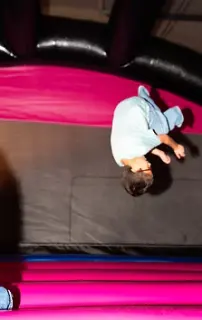 Child jumping on a colorful inflatable bounce area at Bounce City Idaho Falls indoor playground