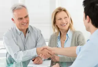 Depositphotos senior happy couple with financial advisor