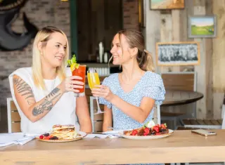 A Man And A Girl Holding Drinks