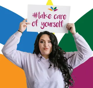 hispanic female holding sign says #takecareofyourself