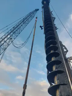 A crane is lifting a large piece of equipment.