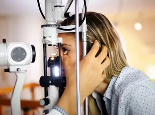 optometrist checking patient eyesight an