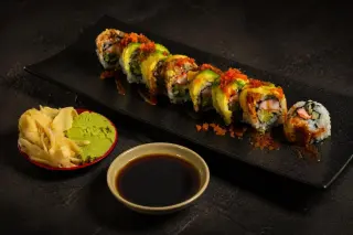 Sushi roll with ginger, wasabi and soy sauce