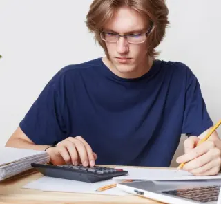 Attractive man faces financial crisis, studies notification from bank, calculates figures. Male student studies math, prepares report, calculates figures. People, business, occupation concept