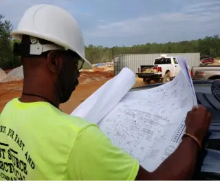 First source electrical company man reading document