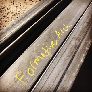 Detail image of steel work with words "Formative Arch." written in yellow.