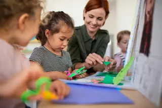 Teacher working with young student
